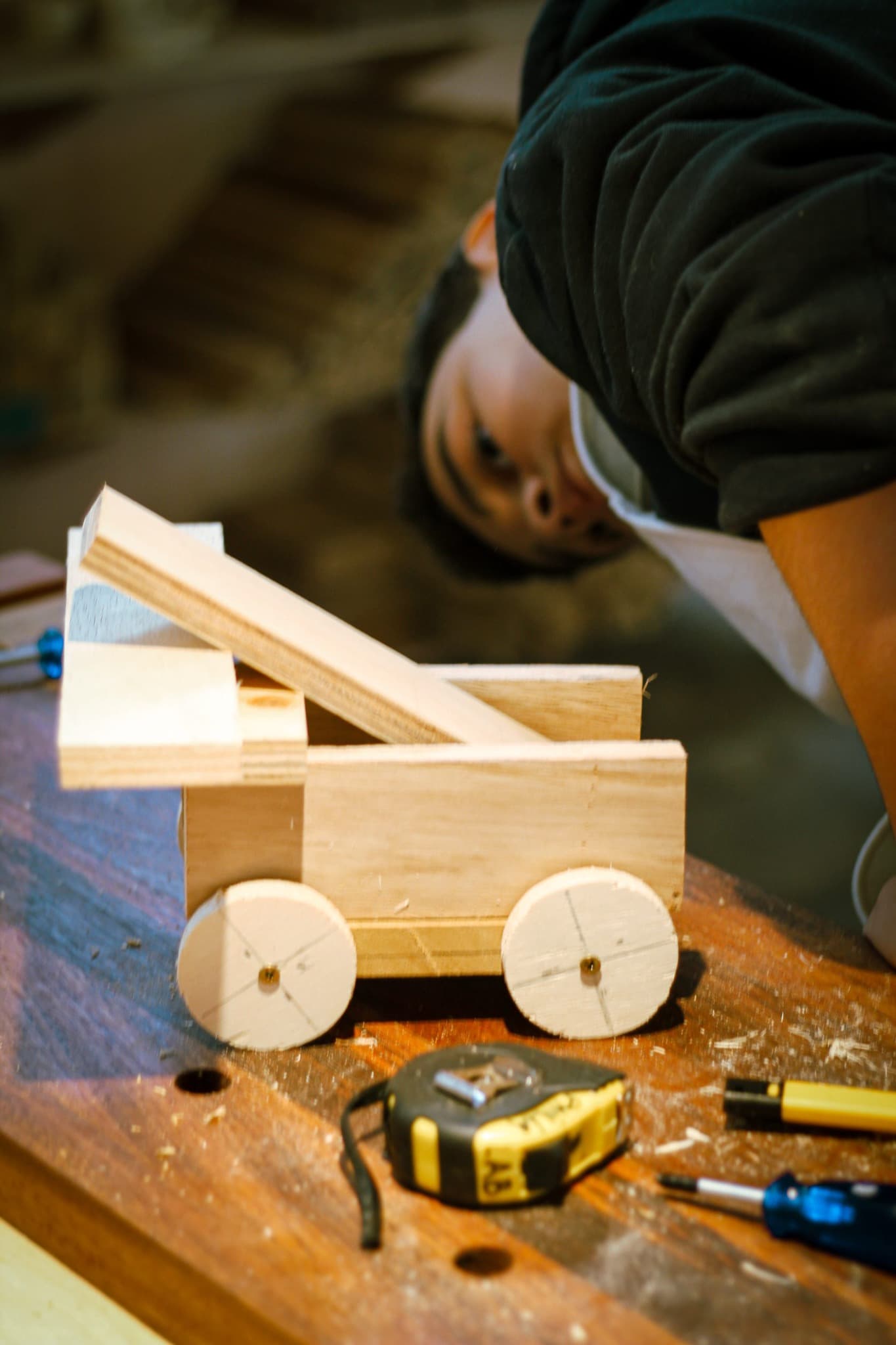 Hands assembling a PHILIA LAB wooden object